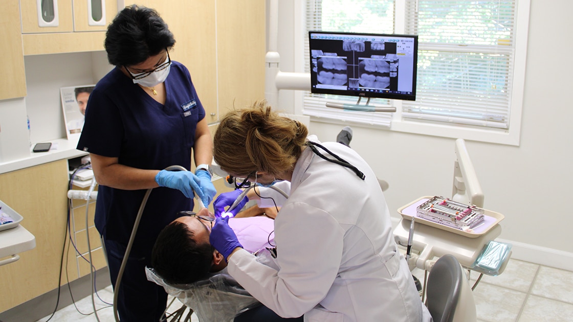 dentist and assistant working on patient